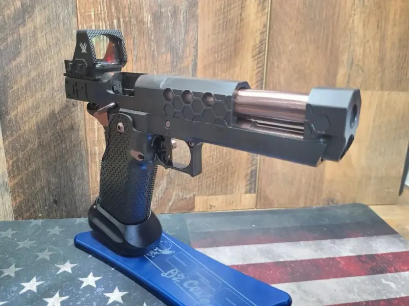 Right side, slide racked, showing barrel and recoil assembly